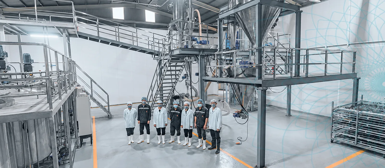 The drying tower inside the factory, with the team standing in front of it